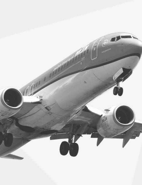 Zwart wit foto van een overvliegend KLM vliegtuig